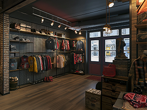 An image of a clothing store with soft lighting and clothing hanging on black wire grid