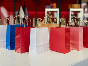 An image of red, white, and blue paper bags sitting on a store counter